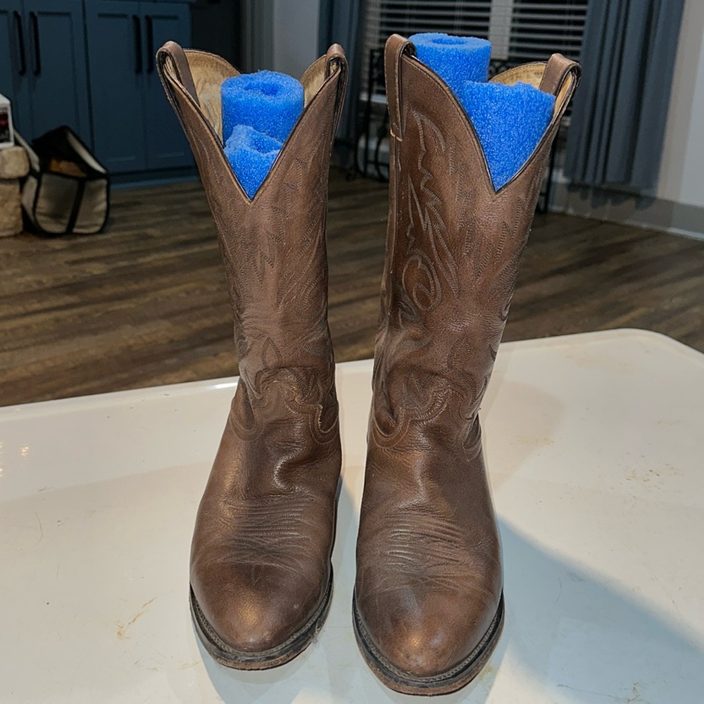 Cowboy boots. Not sure on the brand.